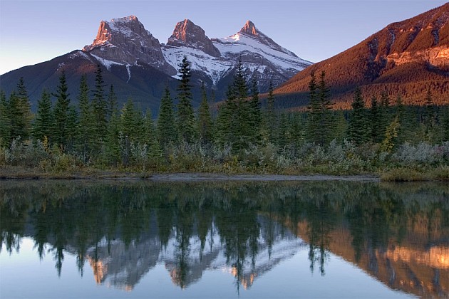 The_Three_Sisters_reflecting_in_the_Bow_River_Canmore